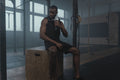 Athlete using professional percussion massage gun on shoulder