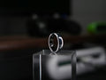 Smart sleep tracking ring displayed on a clear stand