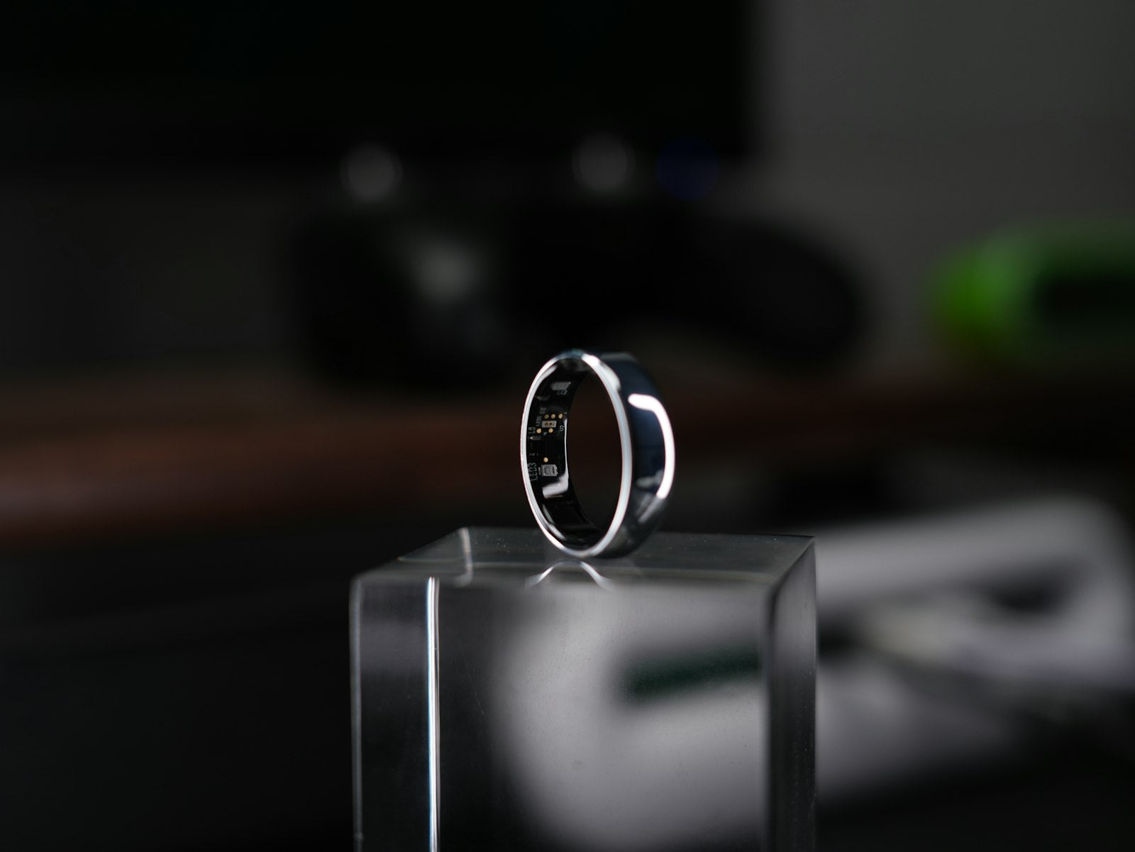 Smart sleep tracking ring displayed on a clear stand